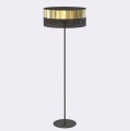 Lampa podłogowa do nowoczesnego salonu w kolorach czarnym i złotym.