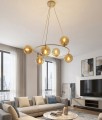Lampa wisząca typu ring w kolorze beżowym z bursztynowymi kloszami.